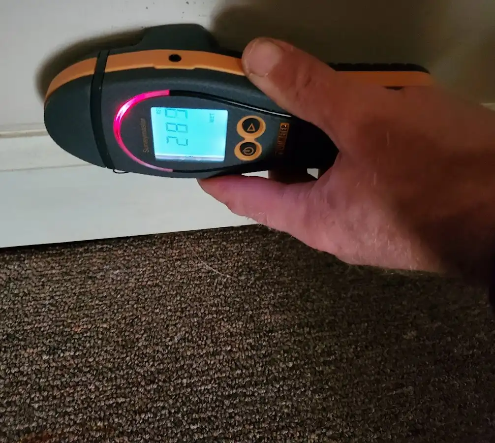 Moisture detection at baseboard during Storm Damage Restoration in Schroeppel